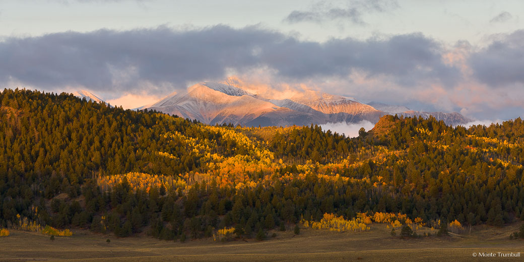 An early fall snowstorm on the Sawatch Range clears at daybreak outside of Buena Vista, Colorado.