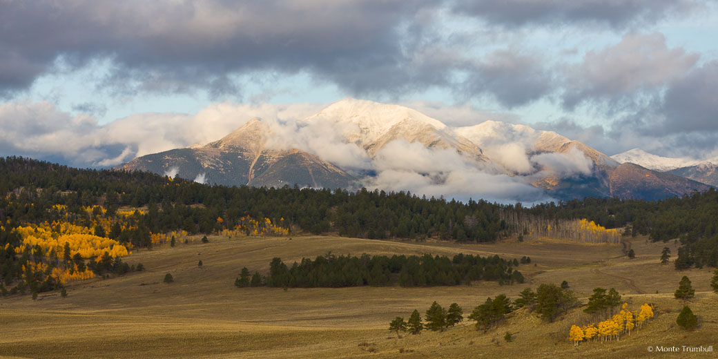 An early fall snowstorm on the Collegiate Peaks clears at daybreak outside of Buena Vista, Colorado.