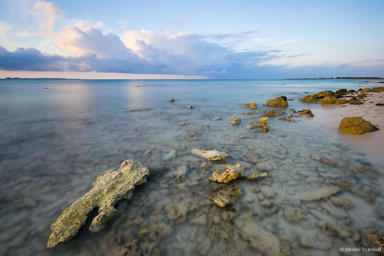 Early morning clouds reflect in the turquoise waters of the Caribbean Sea off the island of Anguilla, BWI.