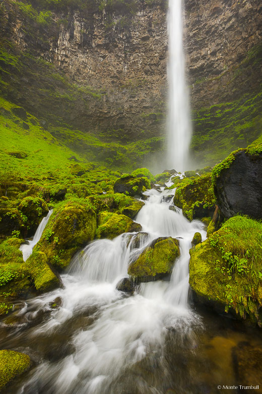 Watson Falls plunges 300 feet over an amphitheater wall of basalt and crashes into a vibrant mossy talus slope in the Umpqua National Forest in Oregon.