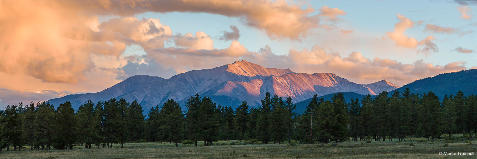 The last light of the day streams down a mountain valley and brushes the top of towering Mount Princeton outside of Buena Vista, Colorado.